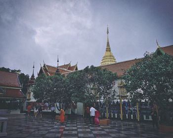 People at temple against sky