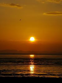 Scenic view of sea against orange sky