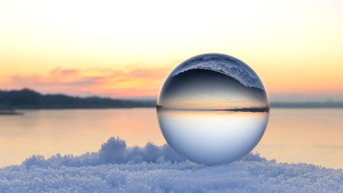 Sunrise on inland lake in northern germany with a lensball