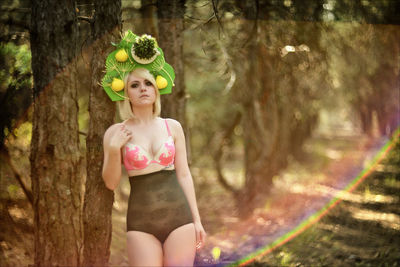 Portrait of smiling young woman in forest