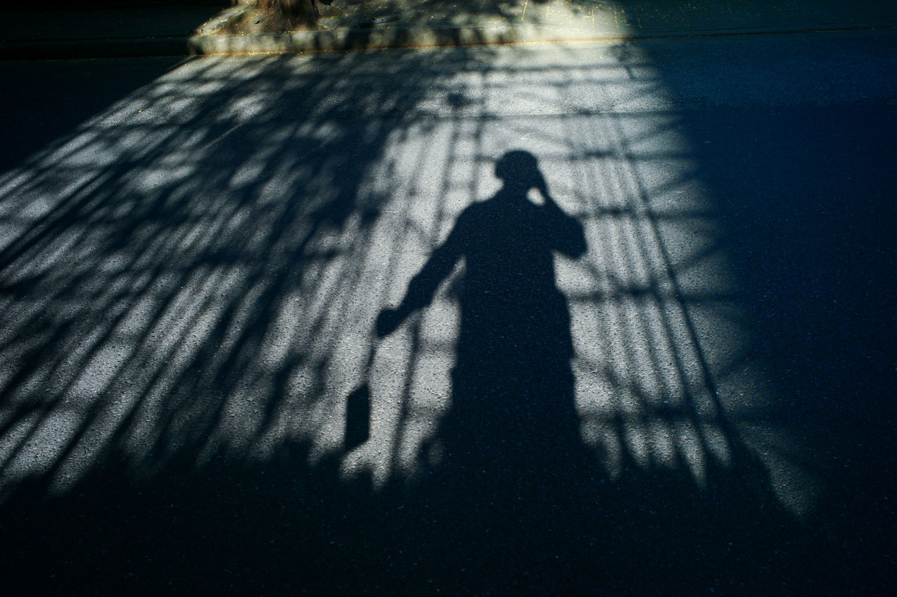 HIGH ANGLE VIEW OF SILHOUETTE SHADOW ON STREET