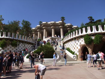 People in front of historical building against clear sky