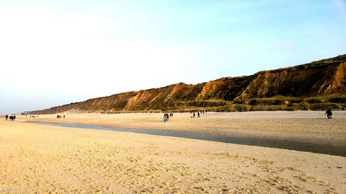 Tourists walking on beach in sylt island