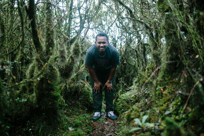 Young man standing in forest