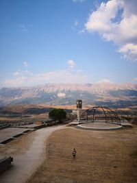 High angle view of woman standing on land against sky