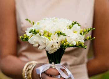 Midsection of woman holding flower bouquet