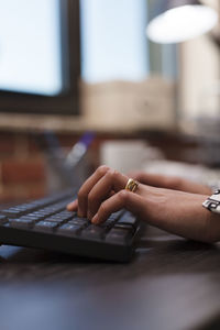 Cropped hand using laptop on table