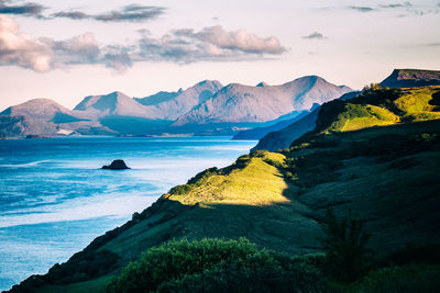 Majestic view over sea and mountains in evening sunlight and large shadows on the island of skye