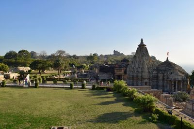 People at temple against clear sky