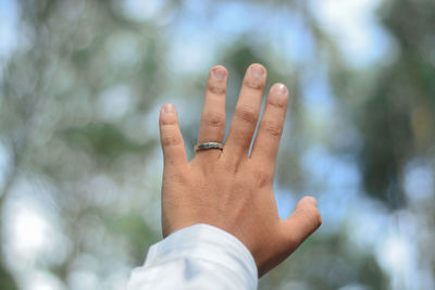 Close-up of human hand against blurred background