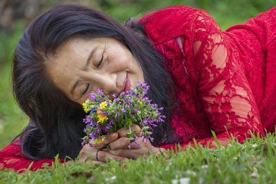 Portrait of beautiful woman with red eyes closed