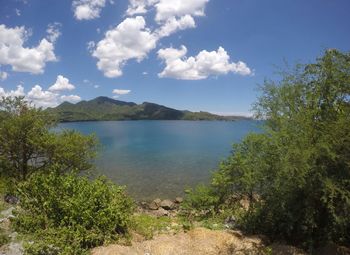 Scenic view of lake against cloudy sky