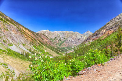 Scenic view of mountains against clear blue sky