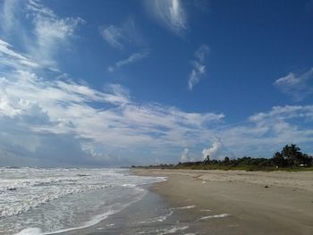 Scenic view of beach against blue sky