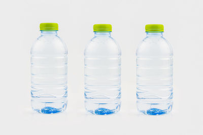 Close-up of wine bottles against white background