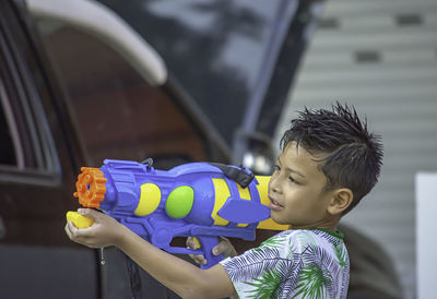 Boy playing with squirt gun