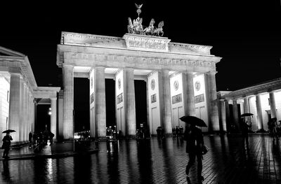 Low angle view of statue in city at night