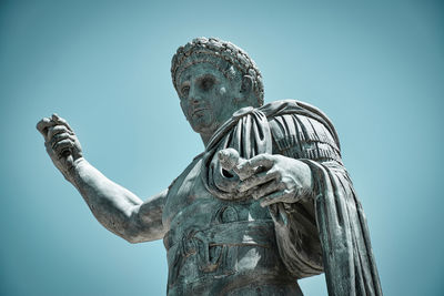 Low angle view of statue against blue sky