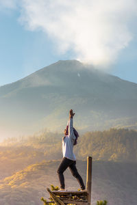 Lady standing on mountain against sky