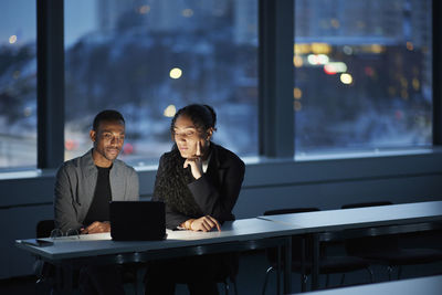 Colleagues working late in office