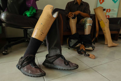Low section of women sitting on chair