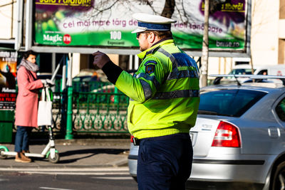 Side view of man standing on street