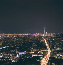 High angle view of illuminated city buildings at night