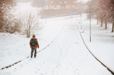 People walking on snow covered landscape