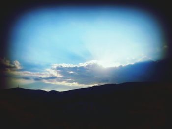 Scenic view of mountains against cloudy sky