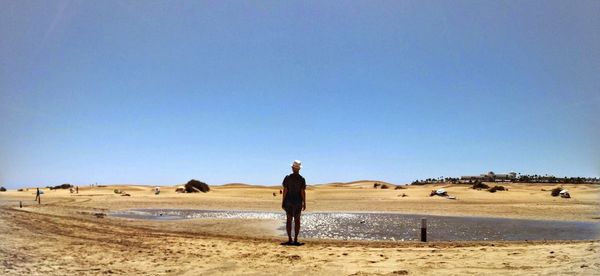 Full length of woman standing on landscape