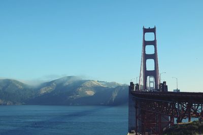 View of bridge over mountain against blue sky