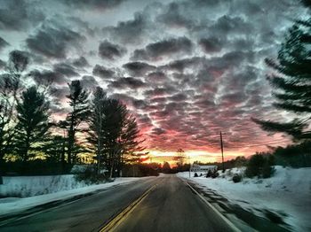 Snow covered road at sunset