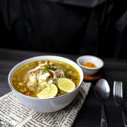 Soto ayam, indonesian food, photographed high angle view decorated with cutlery
