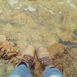 Low section of person standing on rock