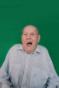 Portrait of man wearing mask against gray background