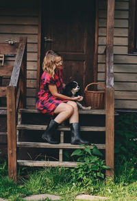 Woman sitting on wooden seat