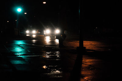 View of wet road at night
