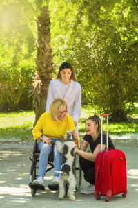 Woman with dog sitting outdoors