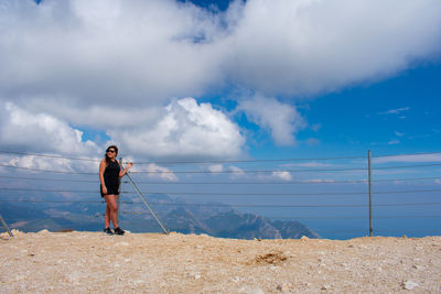 Full length of man standing in sea against sky