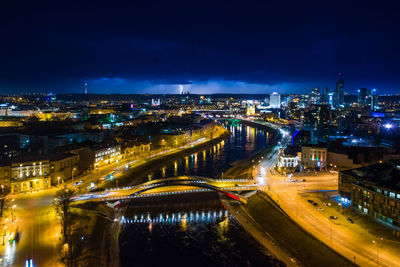 High angle view of illuminated bridge over river in city at night