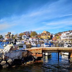 View of river and townscape against blue sky