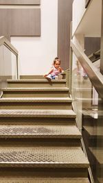 Girl playing on staircase