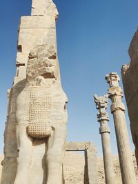 Low angle view of sculpture against building