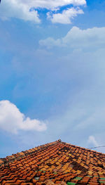 Low angle view of house roof against sky