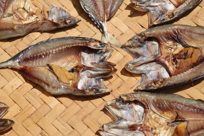 High angle view of dried fish on wicker plate