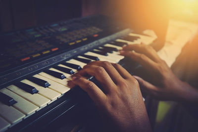 Close-up of hands playing piano