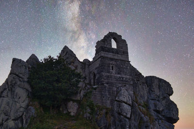 Low angle view of rock formations against sky at night