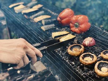 High angle view of person preparing food on barbecue grill