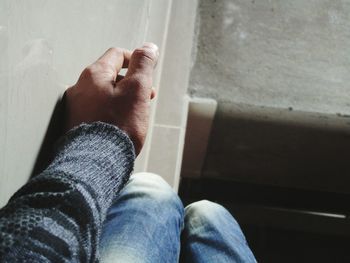 Low section of man and woman sitting on floor