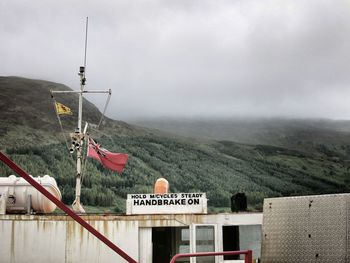 Scenic view of mountains against cloudy sky